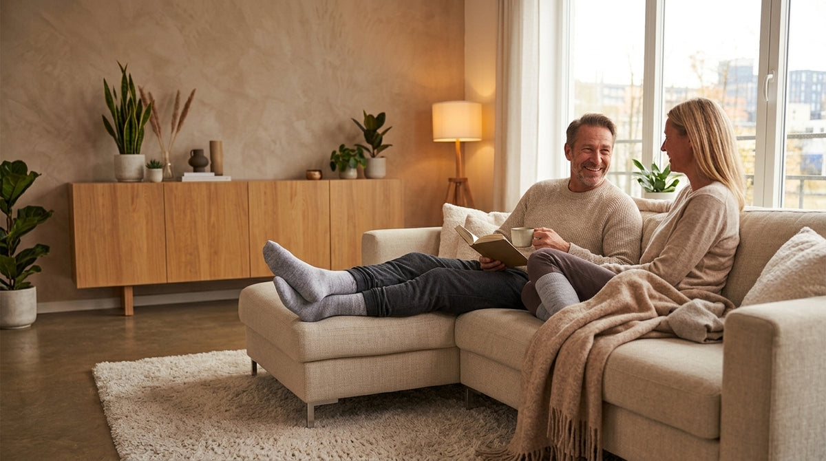 Couple relaxing on the sofa at home in compression socks