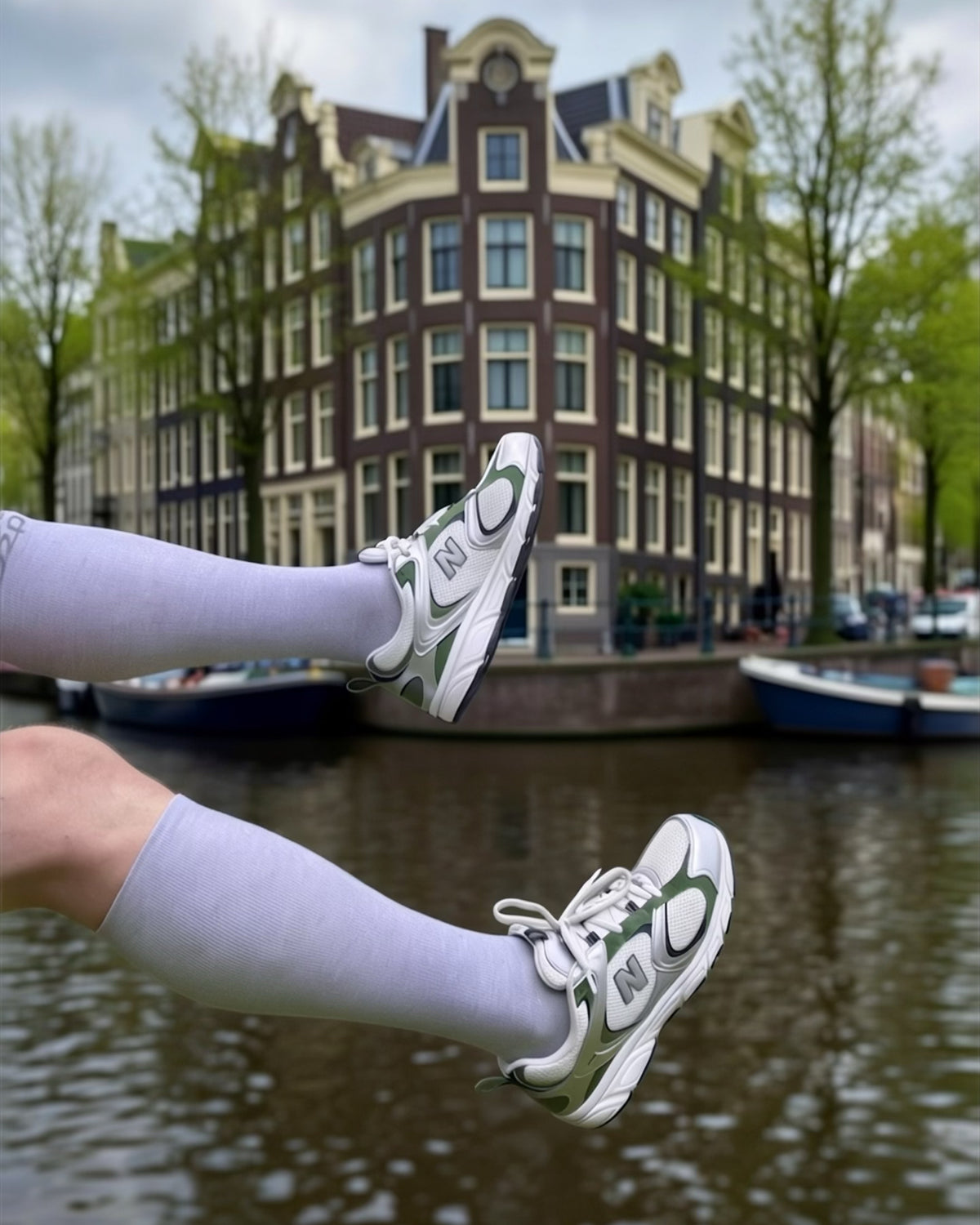 Light blue merino compression socks with trainers by an Amsterdam canal