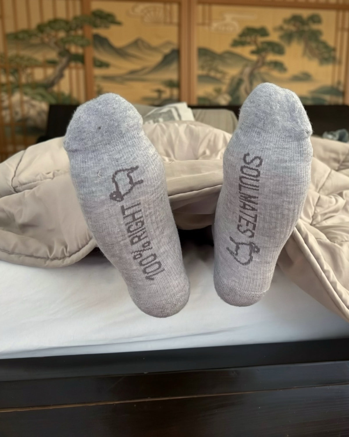 Soles of grey merino compression socks with 100% RIGHT and SOULMATES prints